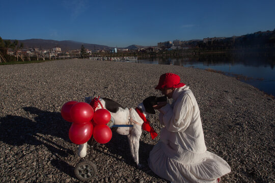 A woman in white with the red balloons 