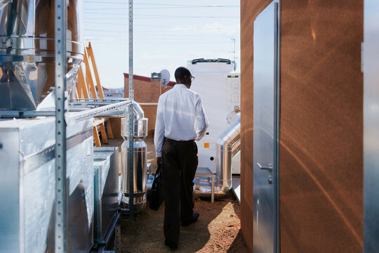 Business professional on industrial rooftop