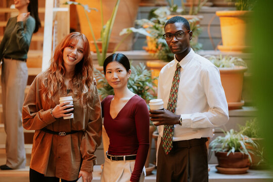 Business professionals enjoying coffee in multiethnic office