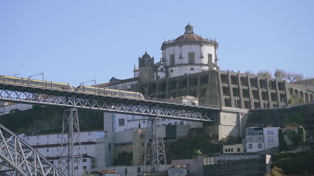Perspective of the metro train passing in front of the historic monastery.