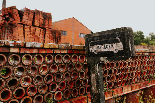 Vintage bus stop by rustic brick wall