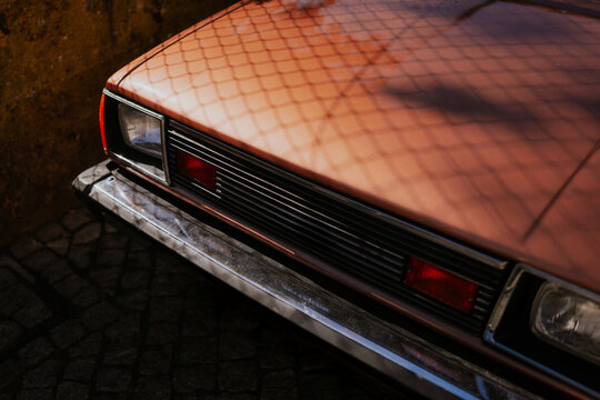 Vintage car with a bronze exterior reflecting sunlight