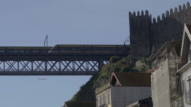Close-up perspective of the iron bridge girders as a metro passes.