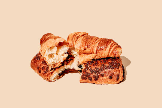 a croissant and a pain au chocolat broken in half