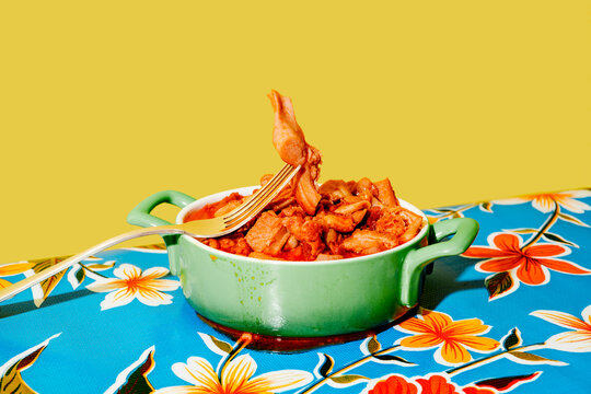 a fork lifting callos con jamon from a bowl