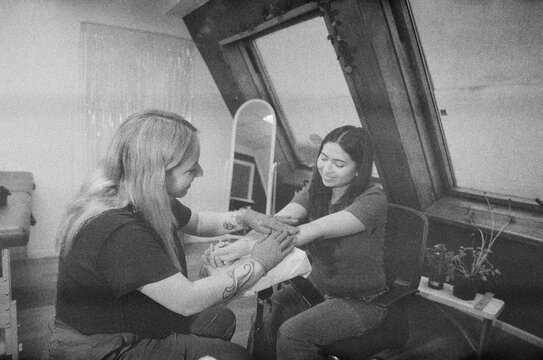 Tattoo Artist and Client Sharing a Moment