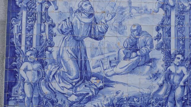 Traditional blue and white Portuguese azulejo tiles depicting a religious scene.