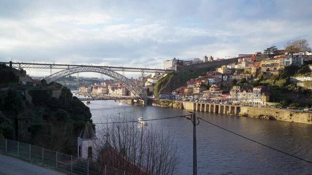 Scenic daylight view of the Porto riverbanks and the bridge structure.