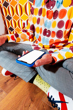 a blank smartphone screen among vibrant retro colors