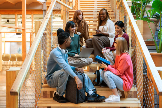 Diverse group collaboration on modern office stairs