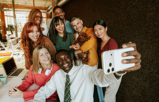 Group of diverse coworkers taking a selfie together