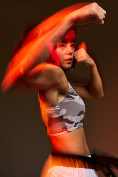 Boxing practice in studio with motion effect and focused stance