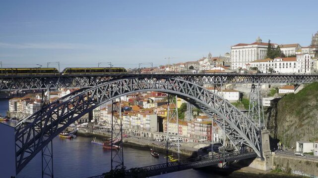 Wide shot of the metallic bridge spanning the Douro river valley.