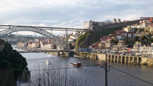 River level perspective of the iconic iron bridge with a small boat passing.