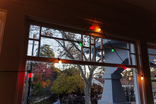 Colorful Lights Hang in a Window During Autumn Time