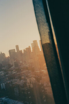 NYC City Skyline at Sunset Seen Through Window From a High Floor hotel