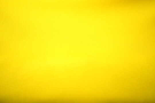 The gleaming yellow background surface is smooth, luxurious, and beautiful.