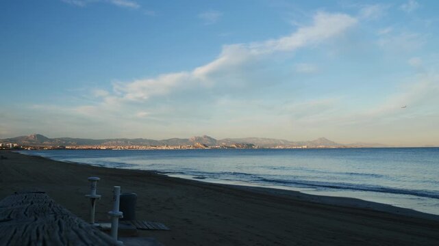 An aircraft approaching the Alicante airport at sunset, the town in the background. Slow motion x0.5.