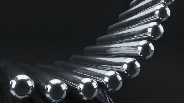 Gleaming metallic spheres linked together with a dark, reflective surface