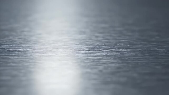 Reflective surface with subtle horizontal textures and a bright light streak