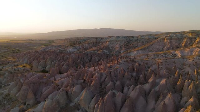 Goreme, Nevsehir, Turkey. Professional aerial footage of Devrent Valley featuring distinctive geological shapes and warm evening lighting. Aerial View, MasterShots, MasterShots, Spiral forward, Spira