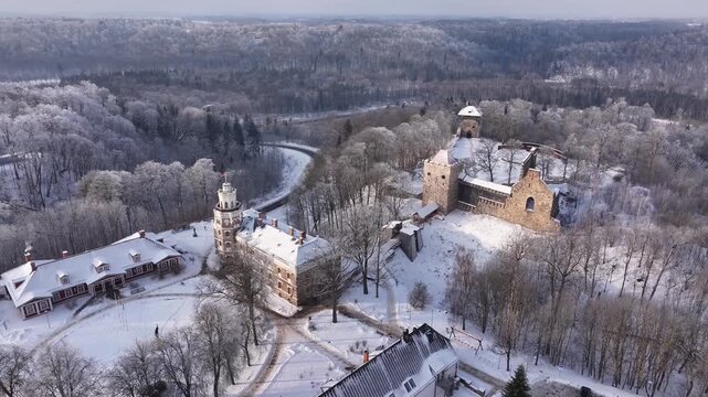 Aerial view of Sigulda s new and medieval castles in Latvia. Below, the New Castle features a rectangular shape with snow-covered roofs and ornate architecture.