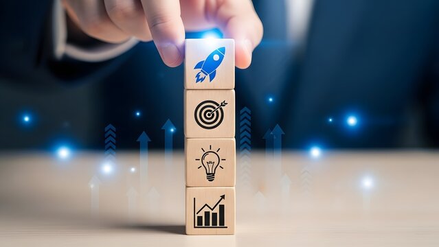 Startup Business Concept with a Hand Stacking Wooden Blocks Showing a Rocket, Target, Ideas, and Growth, Surrounded by Glowing Success Arrows and Vision.