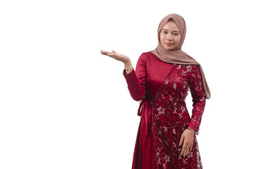 Young muslim woman in red dress and hijab making presenting hand gesture for product display