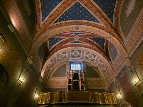 St. Andrew's Church, Spello, Italy. Interior with decorated Gothic vaults, organ loft, and historic artworks