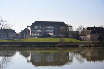 Obraz premium Old town skyline and church reflected in calm river Chalon sur Saone