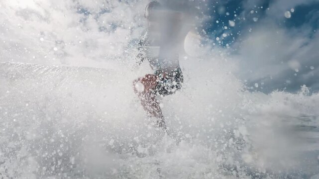 Surfer in wetsuit rides the wave in Atlantic Ocean. Surfboard camera view of the surf rider