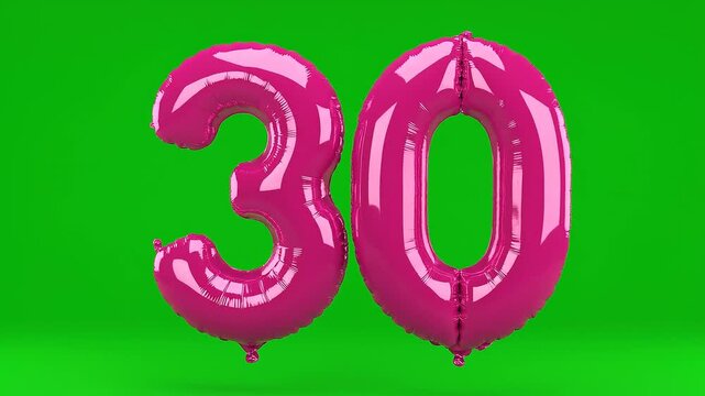 Metallic pink number 30 balloon floating on green background