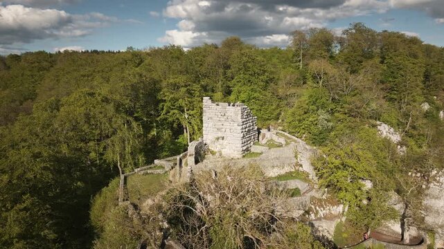 Dynamic 4K UHD drone orbit around Hohengundelfingen castle ruins above the Lauter valley, revealing rolling Swabian Alb hills, forests, and blue skies.