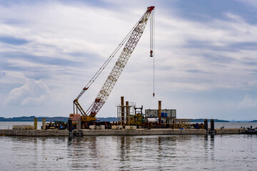 Lattice Boom Crawler Crane on Offshore Barge for Marine Construction © Syakir Zufayri 