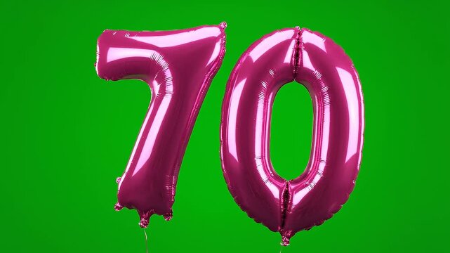 Pink foil balloon number 70 floating on green screen background