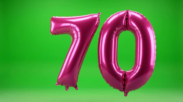 Number 70 pink balloon moving into frame on green background