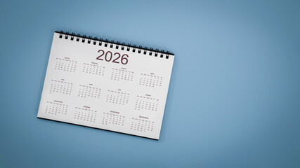 Naklejka premium White calendar laying on blue background planning concept.