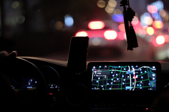 Car interior with navigation system during night city driving