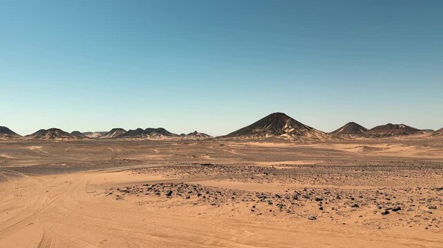 Wide panorama of vast Sahara desert plains with distant mountains of White Desert National Park in Egypt