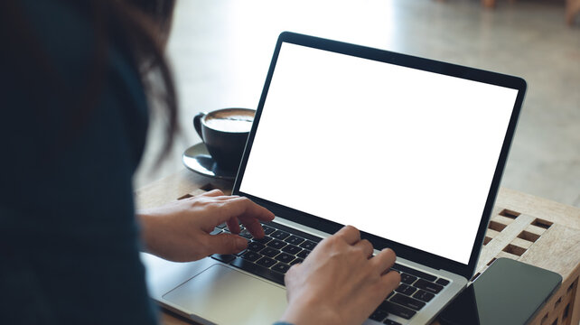 Laptop computer blank screen mockup. Woman working on laptop with empty screen for advertising, contact business search information on desk at coffee shop. marketing and web design template
