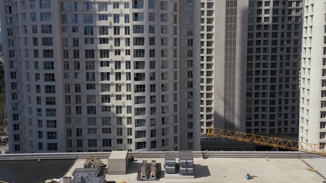 Skyscraper construction site with tower crane aerial view