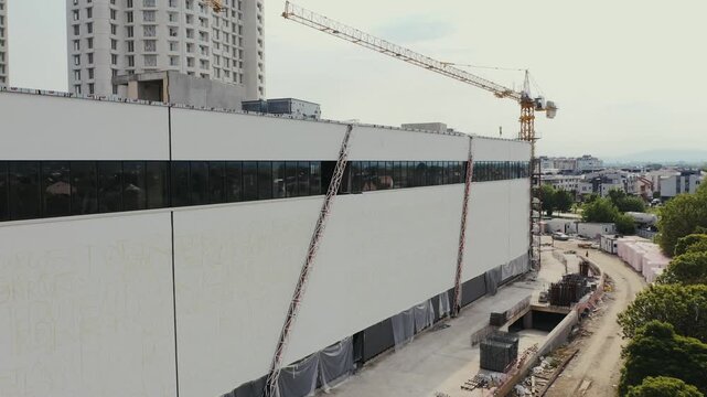 Building facade construction with tower crane
