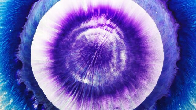 Vibrant blue ink bleeding into white fluid with jagged dark borders