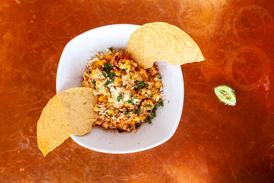 Overhead looking down on bowl of Mexican style of elote