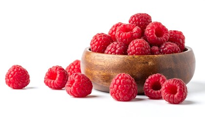 A wooden bowl overflowing with fresh, ripe raspberries, with a few scattered around on a white background.