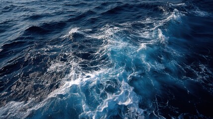 A deep blue ocean with soft foam