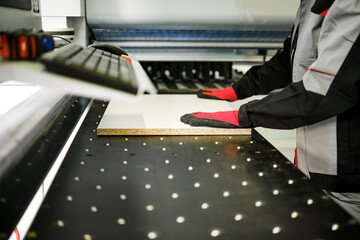Worker uses tools to cut material in a workshop setting during the day