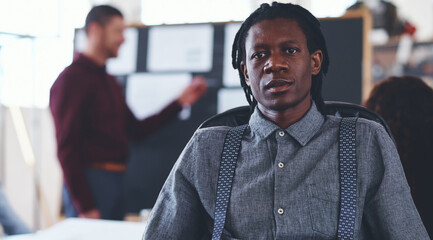 Obraz premium Man, portrait and meeting in office at startup with confidence, career and interior design at company. Person, employee and property developer with pride, team and renovation project at agency