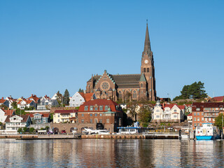 Obraz premium Lysekil town with church and harbour waterfront buildings from Gullmarn fjord, Bohuslän, west coast Sweden