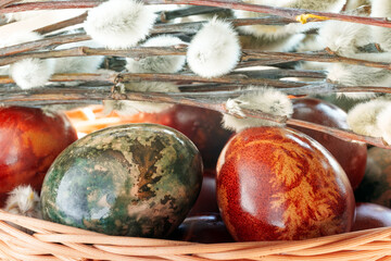 Macro Close-Up of Naturally Dyed Easter Eggs and Pussy Willows in Wicker Basket